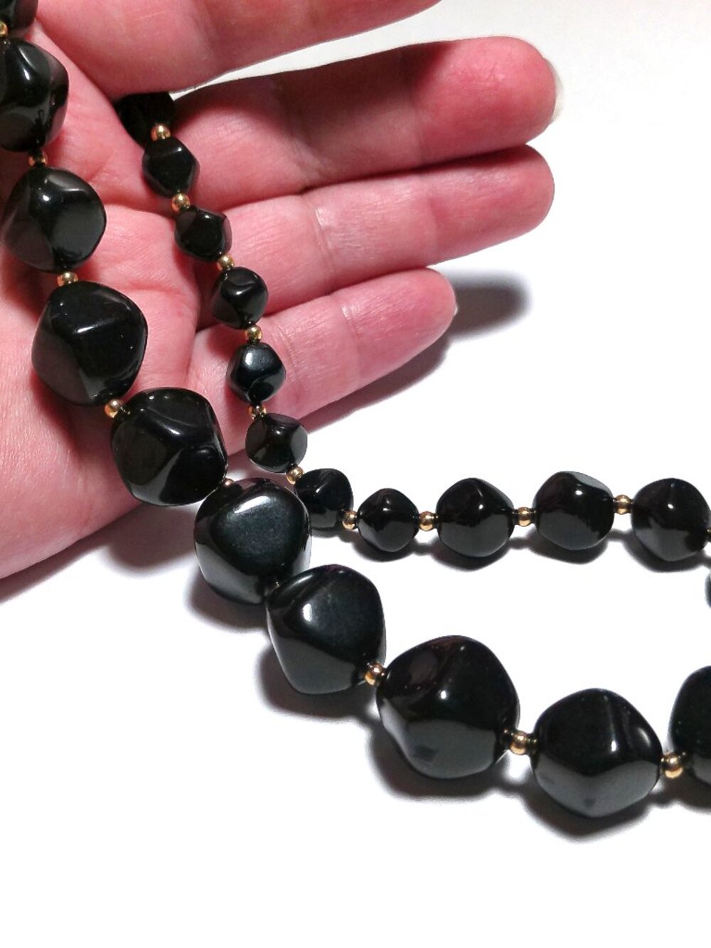 Vintage 1960s Avon necklace featuring a single strand of glossy black plastic